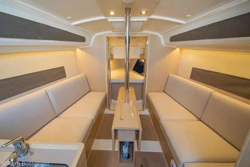 Slide: The Image of Interior of 2022 Beneteau Oceanis 30.1 sailboat, featuring cozy seating and modern design. - 13