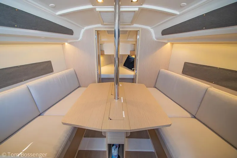 Slide: The Image of Interior of 2022 Beneteau Oceanis 30.1 sailboat, featuring cozy seating and modern design. - 14