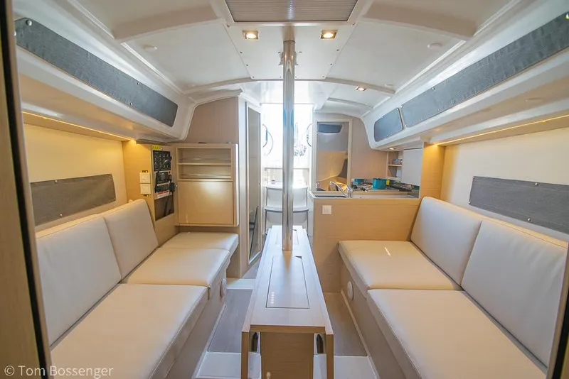 Slide: The Image of Interior of 2022 Beneteau Oceanis 30.1 sailboat, featuring modern seating and compact design. - 15