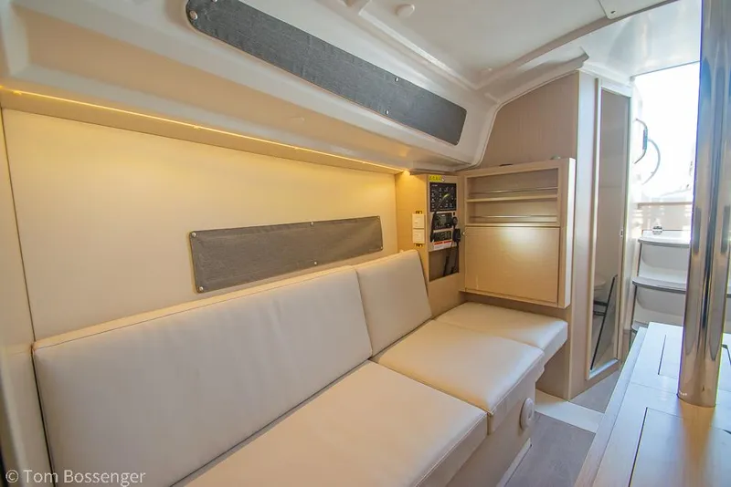 Slide: The Image of Interior of 2022 Beneteau Oceanis 30.1 yacht with modern seating and cabinetry. - 16