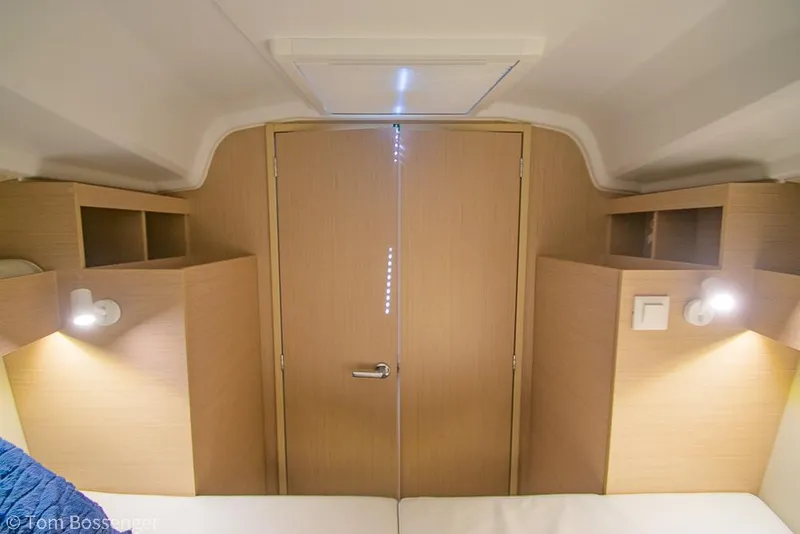 Slide: The Image of Interior cabin of 2022 Beneteau Oceanis 30.1 yacht, featuring wooden finish and cozy lighting. - 19