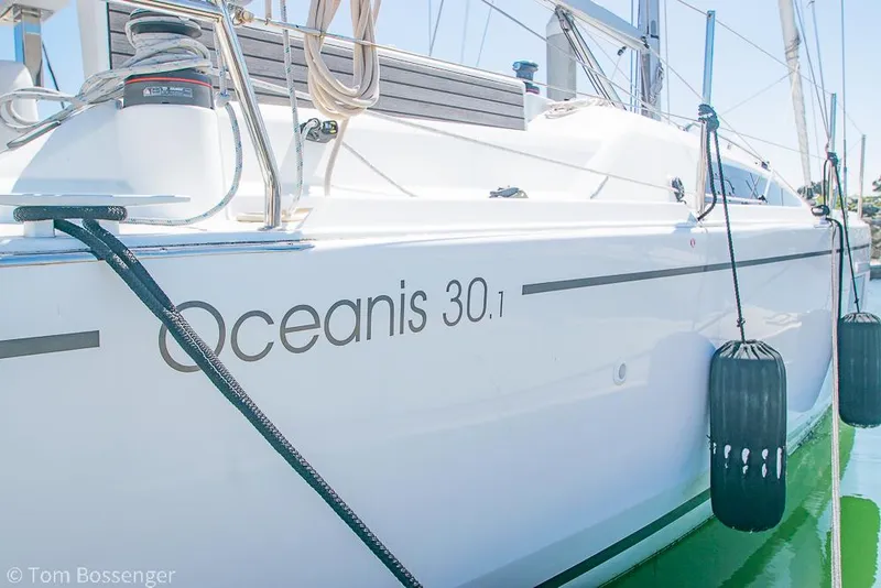 Slide: The Image of 2022 Beneteau Oceanis 30.1 sailboat docked, showcasing sleek design and branding. - 2