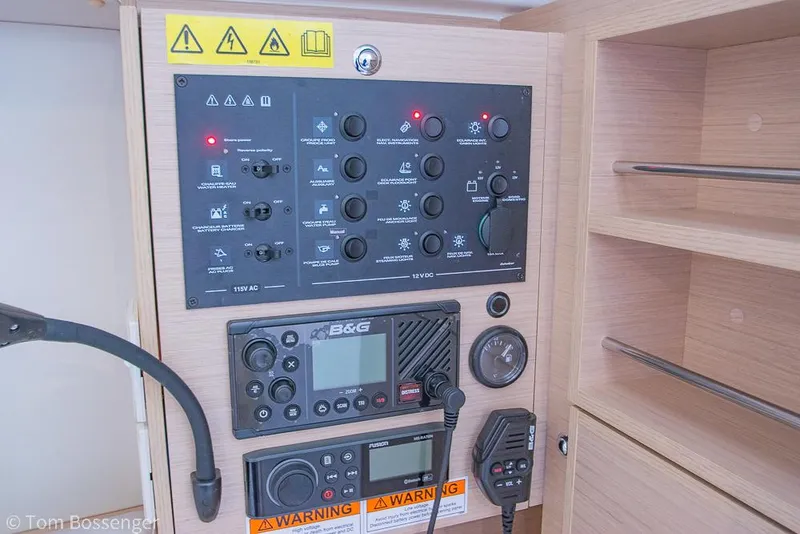 Slide: The Image of Electrical control panel on a 2022 Beneteau Oceanis 30.1 sailboat, featuring navigation and communication equipment. - 20