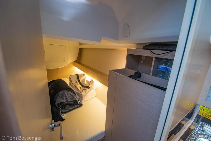 Slide: The Image of Cozy cabin interior of 2022 Beneteau Oceanis 30.1 yacht with storage and bedding. - 22