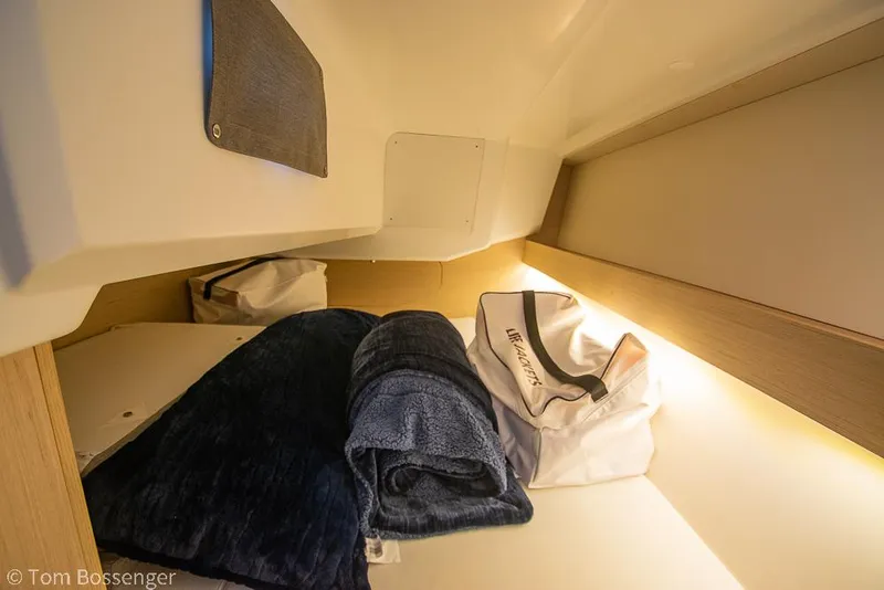 Slide: The Image of Cozy cabin interior of 2022 Beneteau Oceanis 30.1 yacht with bedding and storage. - 23
