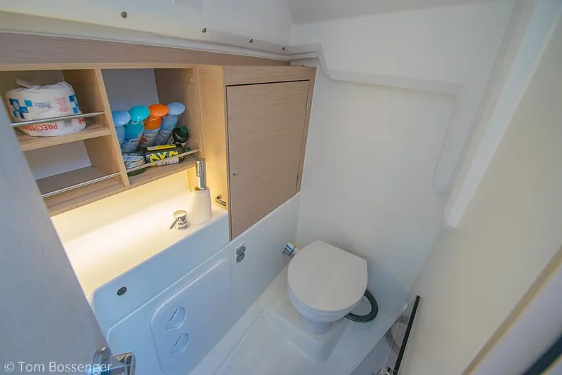 Slide: The Image of Beneteau Oceanis 30.1 2022 bathroom with toilet, sink, and storage shelves. - 24