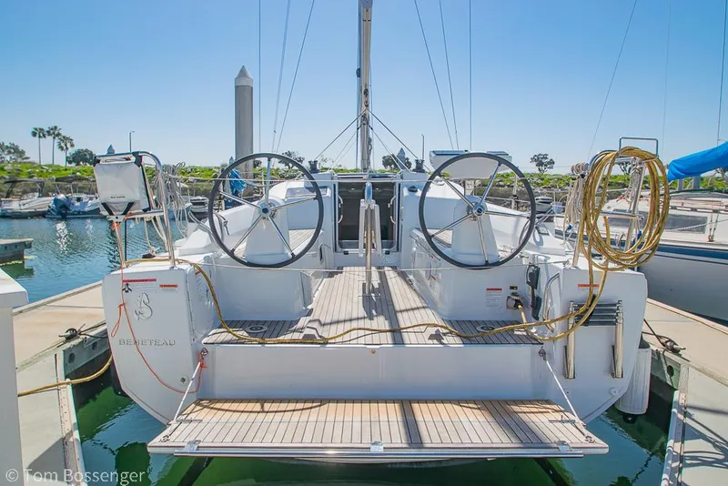 Slide: The Image of Beneteau Oceanis 30.1 sailboat, 2022 model, docked at marina with dual steering wheels. - 3