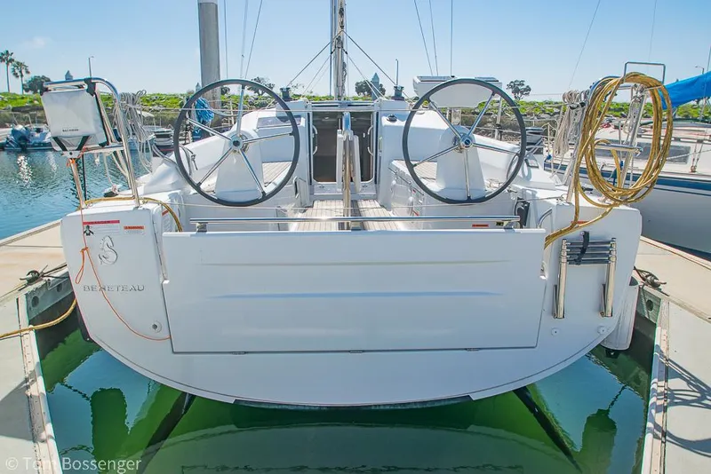 Slide: The Image of 2022 Beneteau Oceanis 30.1 sailboat docked, rear view with dual steering wheels. - 43
