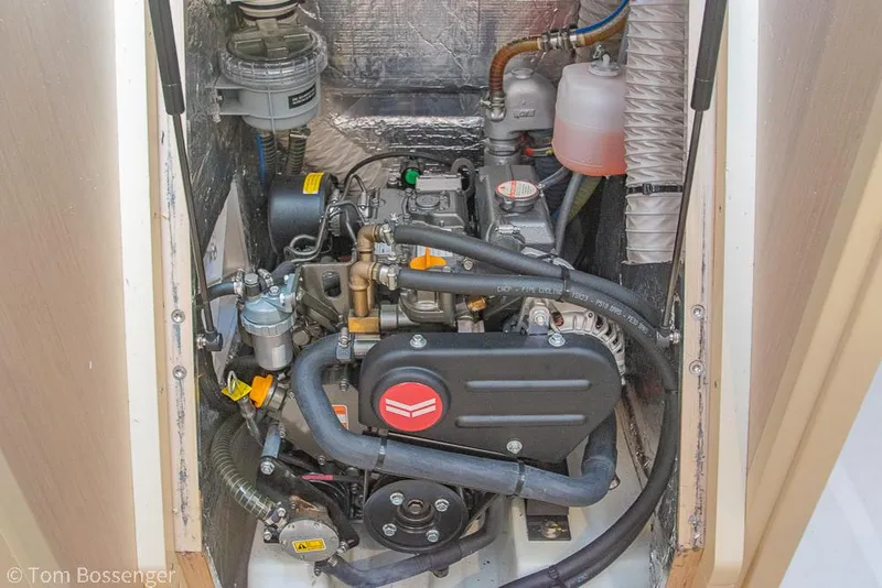 Slide: The Image of Engine compartment of 2022 Beneteau Oceanis 30.1 sailboat, showcasing mechanical components and wiring. - 44