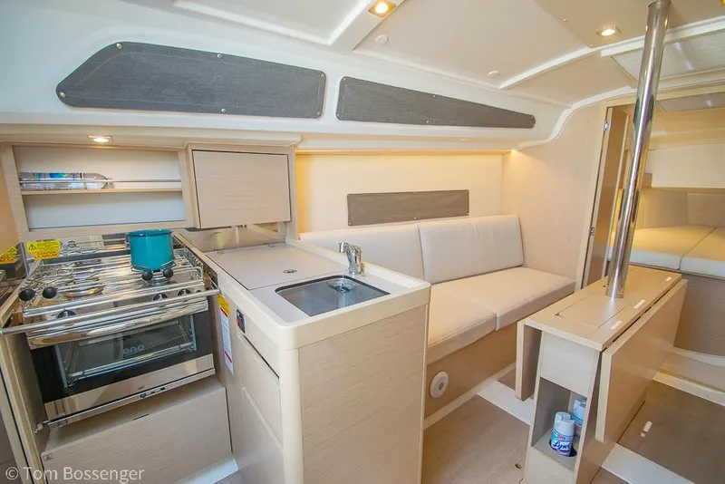 Slide: The Image of Interior of 2022 Beneteau Oceanis 30.1 yacht with modern kitchen and seating area. - 6