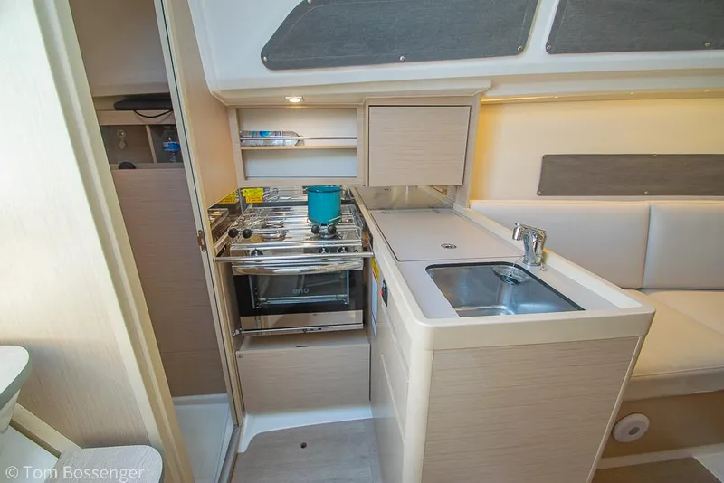 Slide: The Image of Compact kitchen in 2022 Beneteau Oceanis 30.1 yacht with stove, sink, and storage. - 8