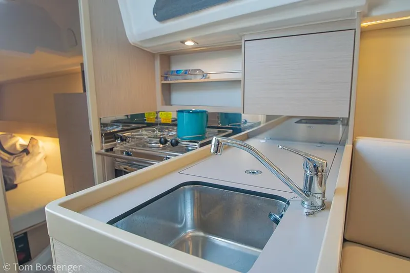 Slide: The Image of Modern kitchen area in a 2022 Beneteau Oceanis 30.1 yacht, featuring a sink and stove. - 9
