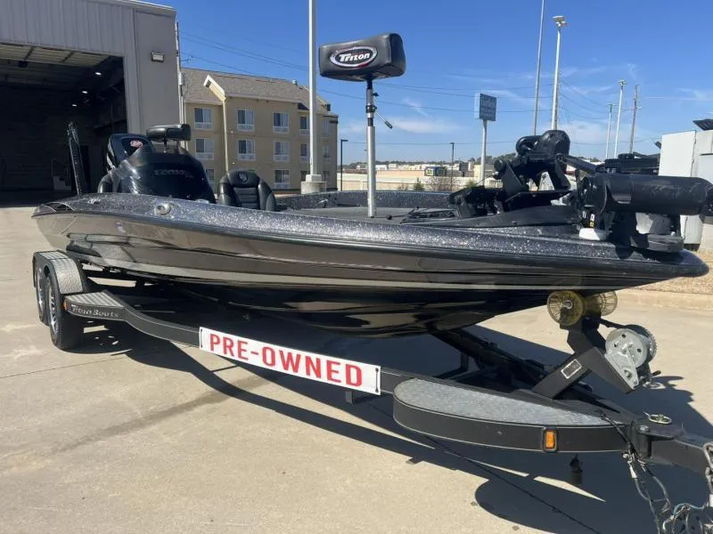 Slide: The Image of Pre-owned 2015 Triton 20TRX boat on trailer, parked outside a building. - 1