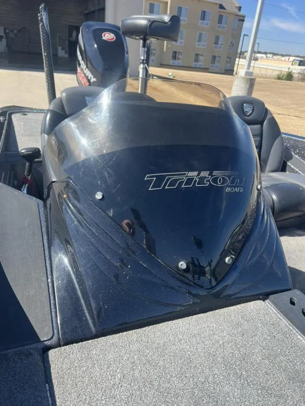 Slide: The Image of 2015 Triton 20TRX boat with Mercury engine, parked outdoors. - 12