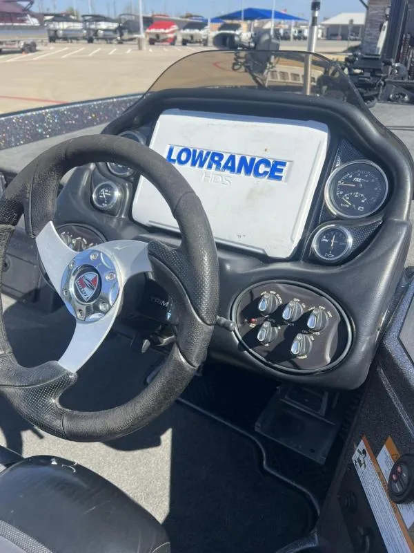 Slide: The Image of 2015 Triton 20TRX boat dashboard with Lowrance HDS display and steering wheel. - 14