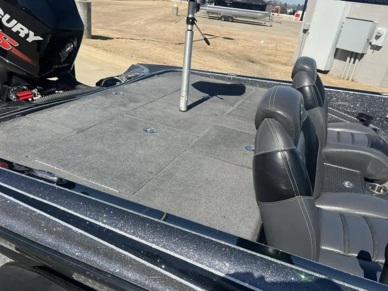 Slide: The Image of 2015 Triton 20TRX boat interior with gray carpet and black leather seats. - 17