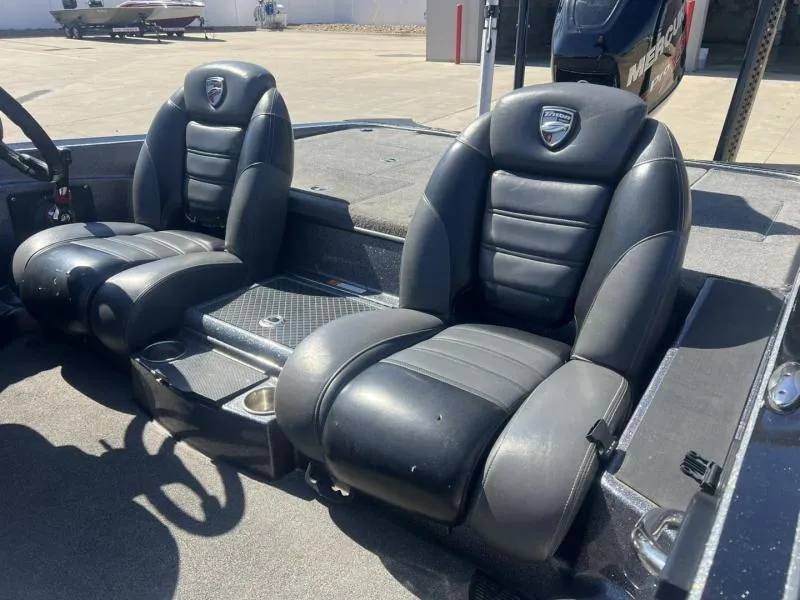 Slide: The Image of 2015 Triton 20TRX boat interior with black leather seats and console. - 20