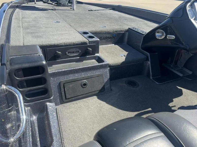 Slide: The Image of 2015 Triton 20TRX boat interior with Garmin equipment and storage compartments. - 21