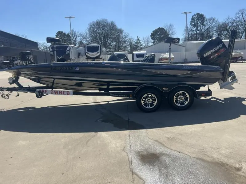Slide: The Image of 2015 Triton 20TRX boat on trailer, pre-owned, parked outdoors. - 6