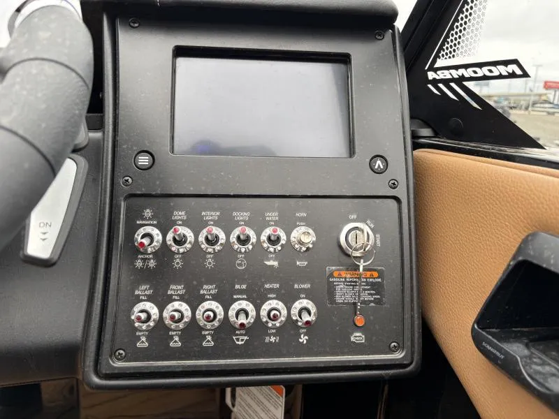 Slide: The Image of Control panel of a 2025 Moomba Max boat with various switches and a display screen. - 17