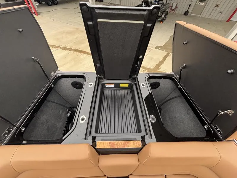 Slide: The Image of 2025 Moomba Max boat storage compartments open, showcasing spacious interior design. - 20