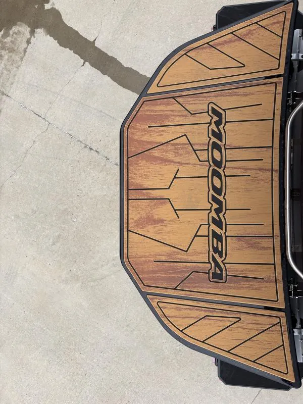 Slide: The Image of 2025 Moomba Max boat deck with wood finish design. - 24