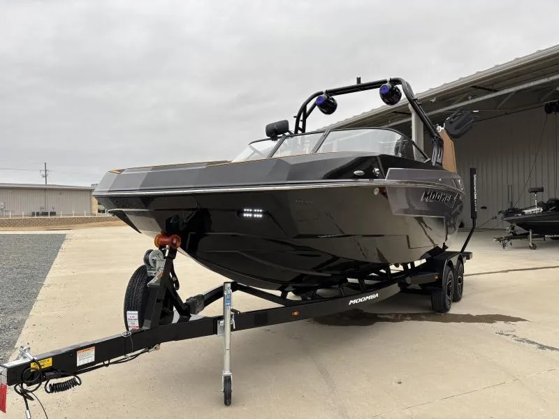 Slide: The Image of 2025 Moomba Max boat on trailer, parked outdoors near a building. - 3