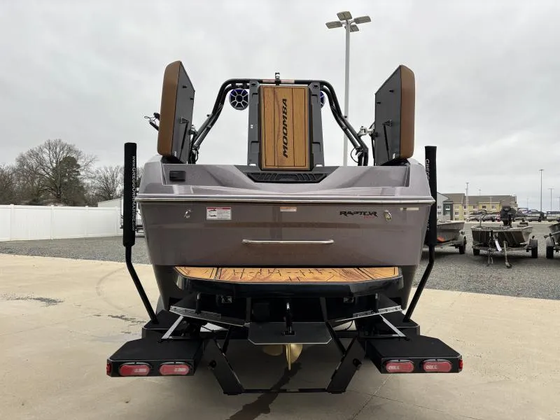Slide: The Image of 2025 Moomba Max boat rear view with Raptor engine, parked outdoors. - 5