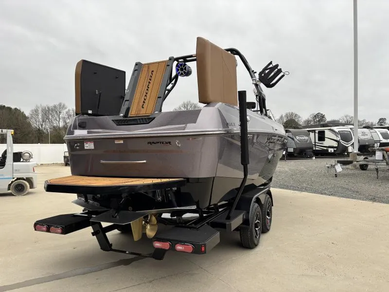 Slide: The Image of 2025 Moomba Max boat on trailer, rear view, parked outdoors. - 7