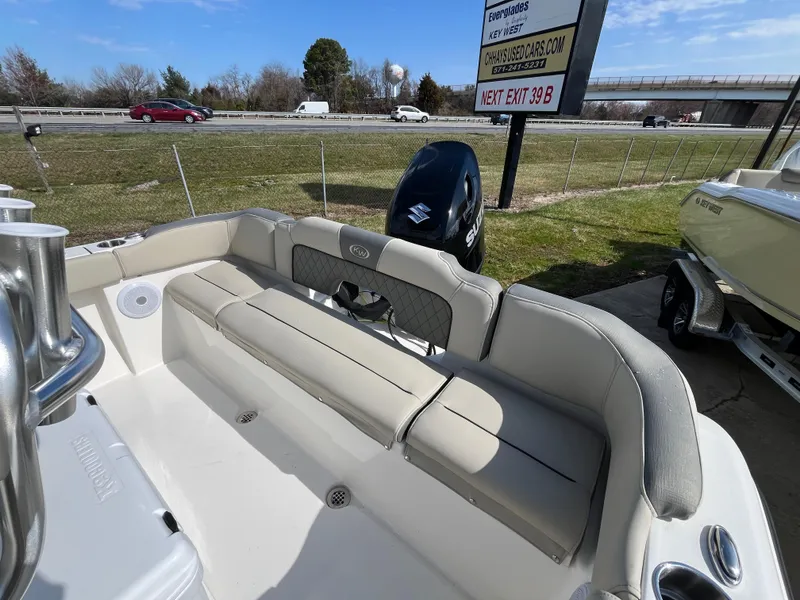 Slide: The Image of 2025 Key West 203 FS boat interior with seating and Suzuki outboard motor. - 15