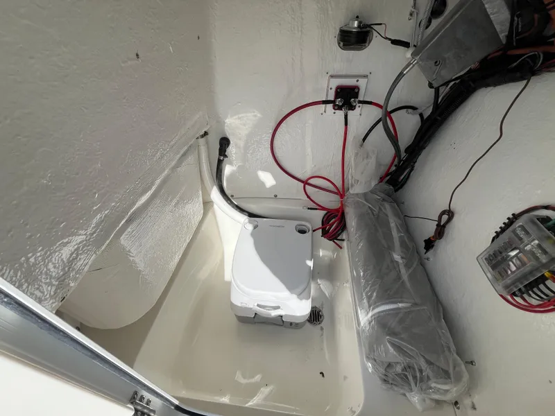 Slide: The Image of Interior of 2025 Key West 203 FS boat with wiring and portable toilet. - 18