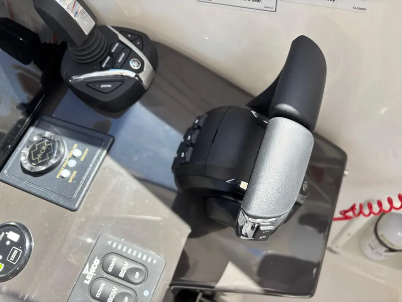 Slide: The Image of Control panel of 2025 Pursuit OS 355 Offshore boat with throttle and joystick. - 25