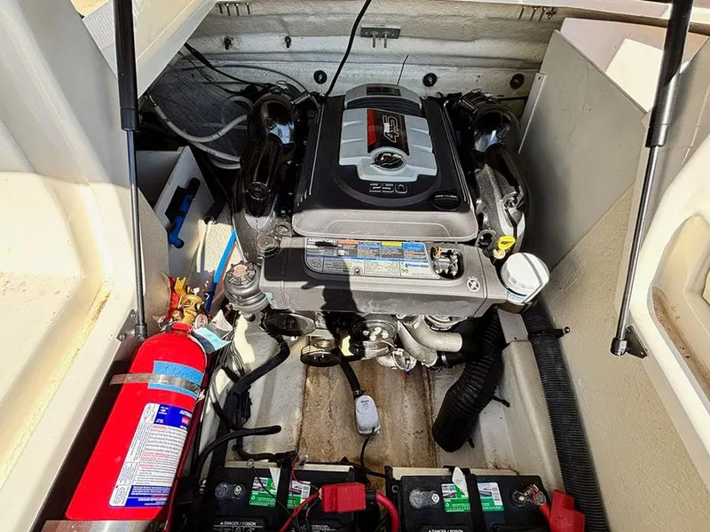 Slide: The Image of Engine compartment of a 2016 Sea Ray 240 Sundeck with visible fire extinguisher and batteries. - 15