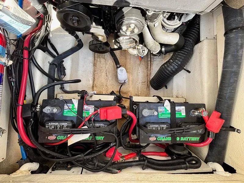 Slide: The Image of Engine compartment of a 2016 Sea Ray 240 Sundeck with dual marine batteries. - 16