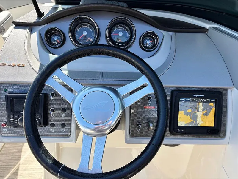 Slide: The Image of Dashboard of 2016 Sea Ray 240 Sundeck with steering wheel and navigation system. - 19