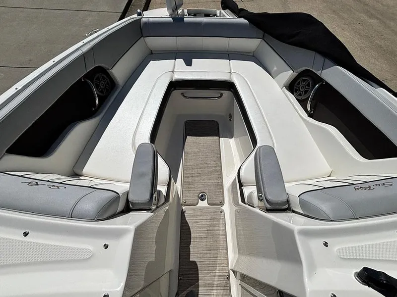 Slide: The Image of 2016 Sea Ray 240 Sundeck boat interior with white seating and speakers. - 23