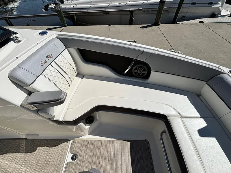Slide: The Image of 2016 Sea Ray 240 Sundeck interior with white seating and speaker detail. - 24
