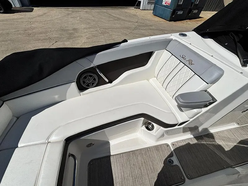 Slide: The Image of 2016 Sea Ray 240 Sundeck interior with white seating and speaker detail. - 25