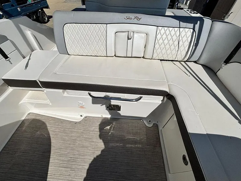 Slide: The Image of 2016 Sea Ray 240 Sundeck interior seating with white upholstery and diamond stitching. - 7