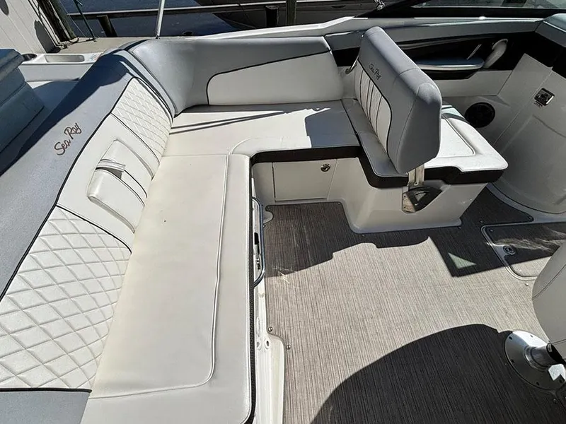 Slide: The Image of 2016 Sea Ray 240 Sundeck interior with white cushioned seating and elegant design. - 8