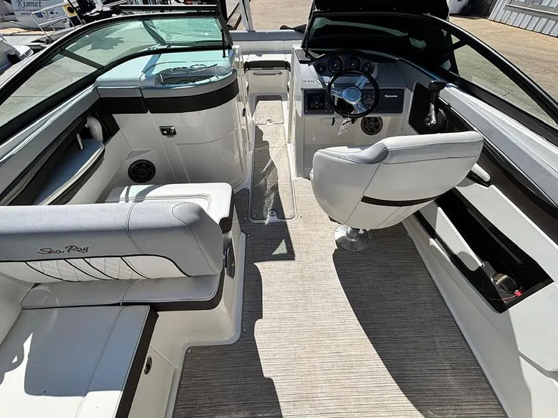 Slide: The Image of 2016 Sea Ray 240 Sundeck interior with seating and steering console. - 9