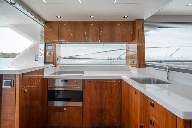Slide: The Image of Luxurious kitchen interior of 2020 Sunseeker 52 Manhattan yacht with modern wood cabinetry. - 13
