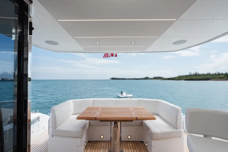 Slide: The Image of Luxurious Sunseeker 52 Manhattan yacht deck with ocean view, featuring elegant seating and table. - 25