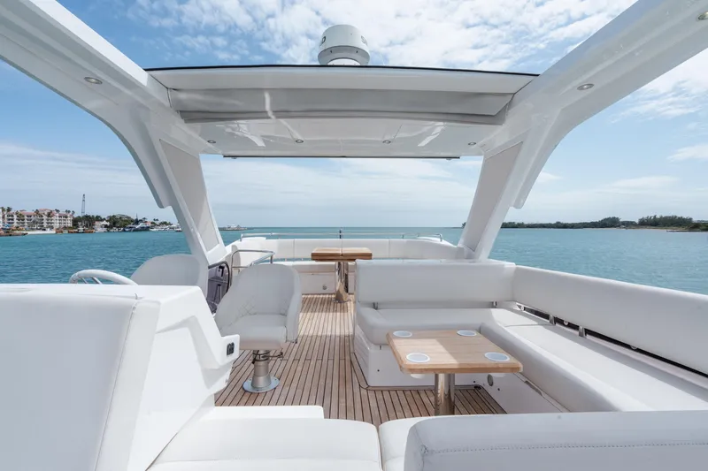 Slide: The Image of Luxurious Sunseeker 52 Manhattan yacht interior with white seating, wooden deck, and ocean view. - 27