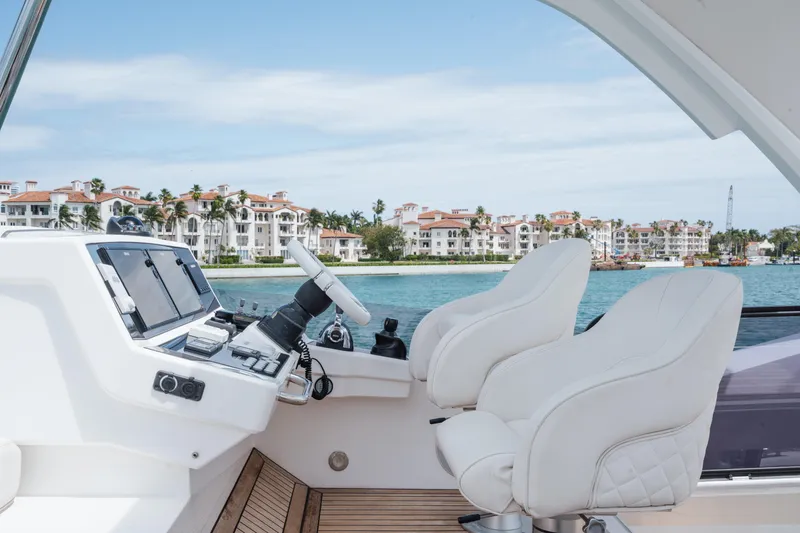 Slide: The Image of Cockpit of 2020 Sunseeker 52 Manhattan yacht with luxury seating and waterfront view. - 31
