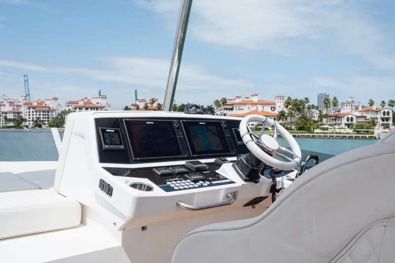 Slide: The Image of Helm of 2020 Sunseeker 52 Manhattan yacht with modern controls and waterfront view. - 32