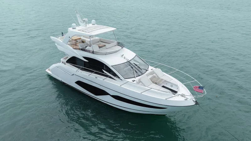 Slide: The Image of Luxurious 2020 Sunseeker 52 Manhattan yacht cruising on calm blue waters. - 4