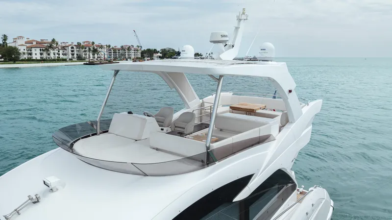 Slide: The Image of 2020 Sunseeker 52 Manhattan yacht cruising on serene blue waters. - 5