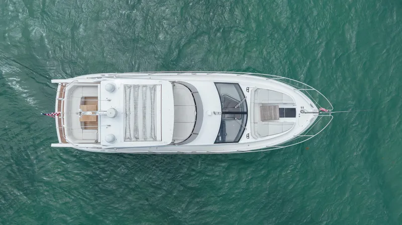 Slide: The Image of Aerial view of 2020 Sunseeker 52 Manhattan yacht on turquoise water. - 7