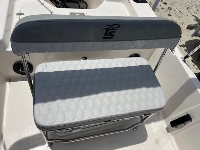 Slide: The Image of 2025 Carolina Skiff 178 JLS boat seat with gray cushioned backrest and white textured seat. - 4